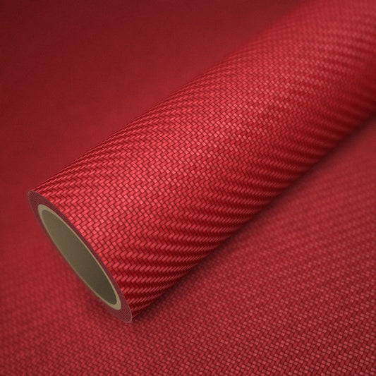 Rollo de vinilo carbono 3D rojo sobre una lámina del mismo vinilo