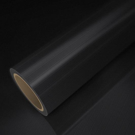 Rollo de vinilo negro cepillado sobre una lámina del mismo vinilo